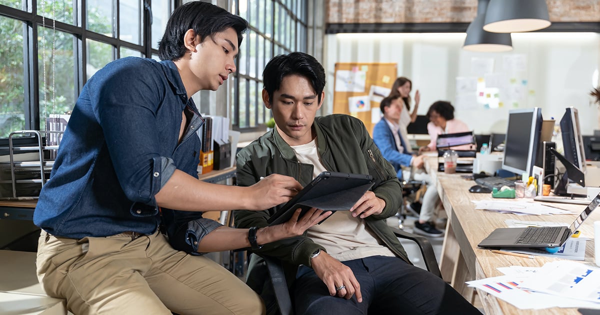 people reviewing in a tablet